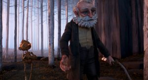 Kadr z filmu animowanego techniką animacji lalkowej. W lesie. Starszy mężczyzna z siwymi włosami, brodą i wąsami stoi przodem, po prawej stronie kadru. Ma na sobie piaskową, płócienną koszulę, brązowy płaszcz, ciemne spodnie. Za nim, po lewej stronie kadru, drewniany chłopiec z długim nosem.